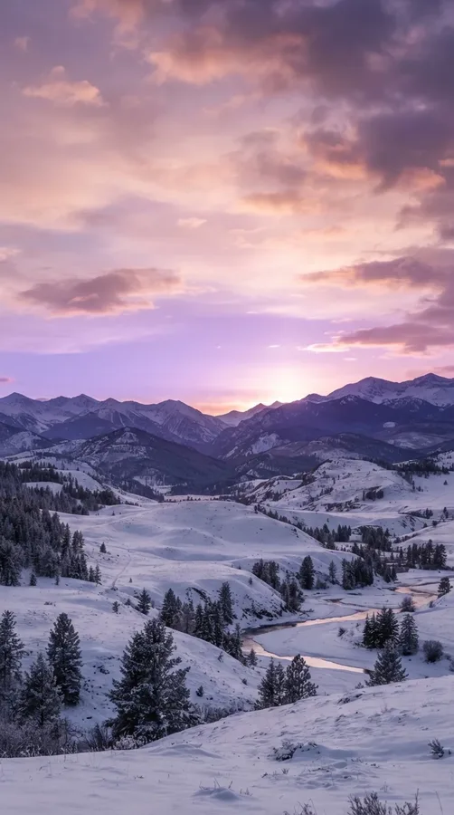 Dreamy purple winter sunset over snow-covered hills beneath pink and lavender clouds.