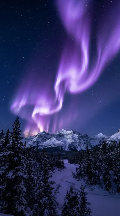 Glowing violet northern lights above a dark snowy mountain landscape.